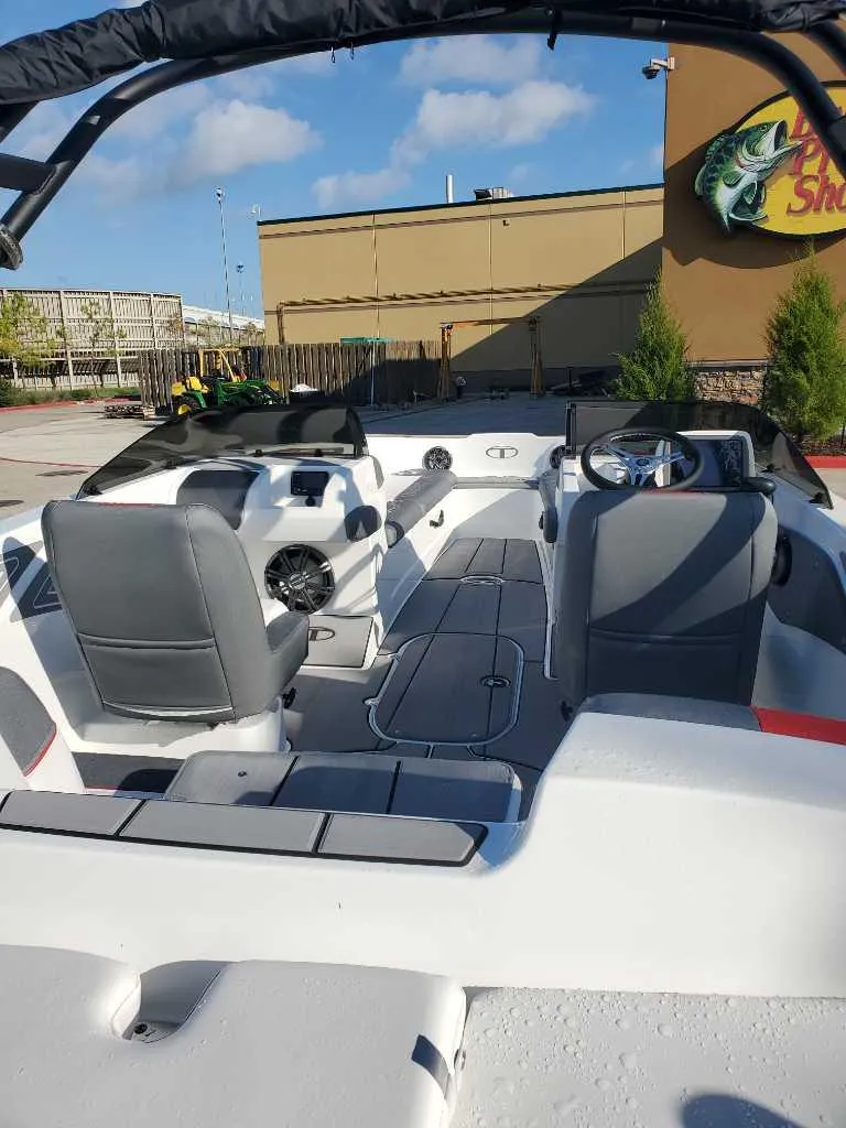 Slide: The Image of 2024 Tahoe T21 boat interior with dual seating and modern dashboard. - 4