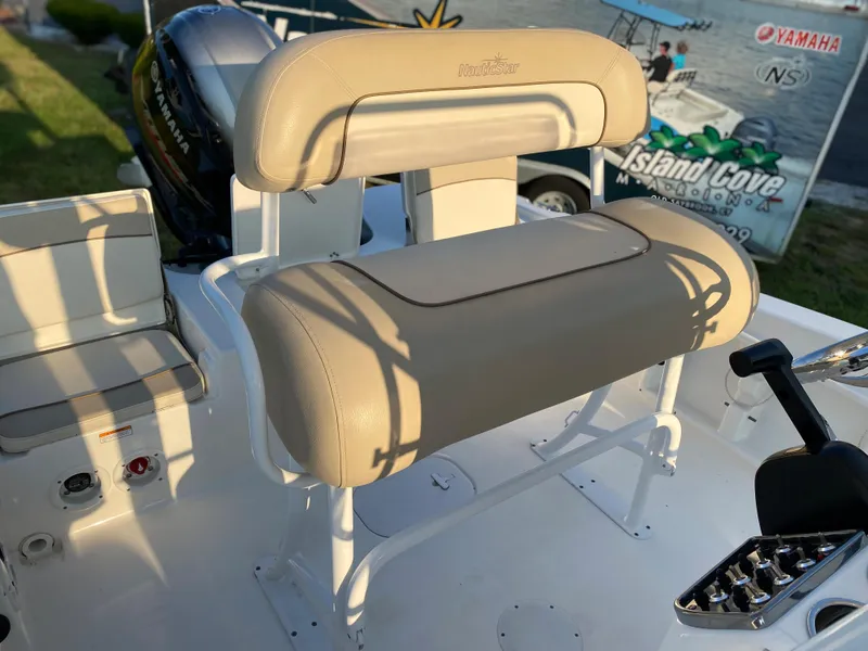 Slide: The Image of 2022 NauticStar 191 Hybrid boat interior with beige seating and control panel. - 10