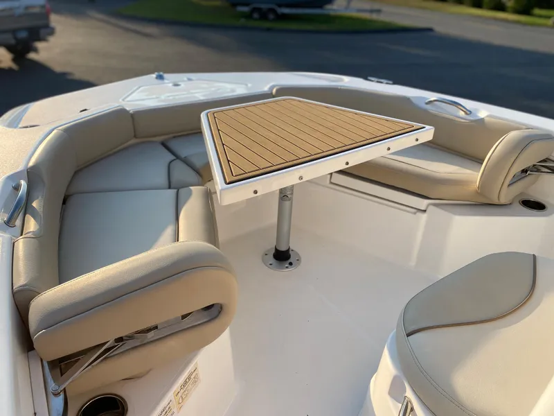 Slide: The Image of 2022 NauticStar 191 Hybrid boat with cushioned seating and a central table. - 14