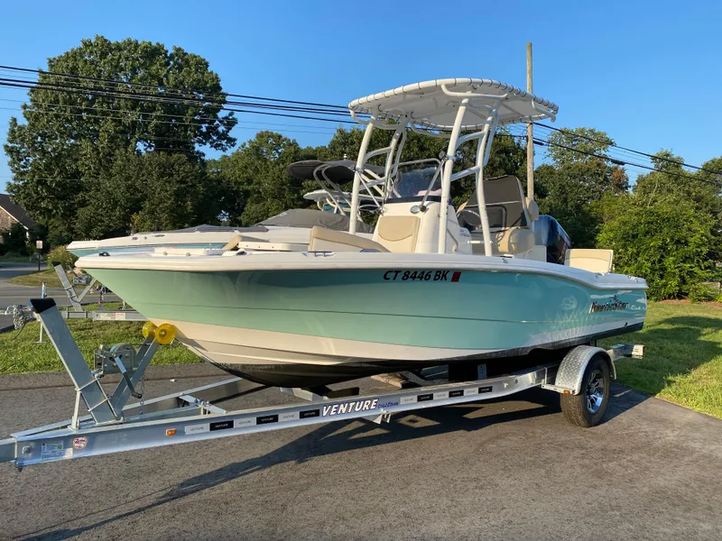 Slide: The Image of 2022 NauticStar 191 Hybrid boat on Venture trailer in outdoor setting. - 15