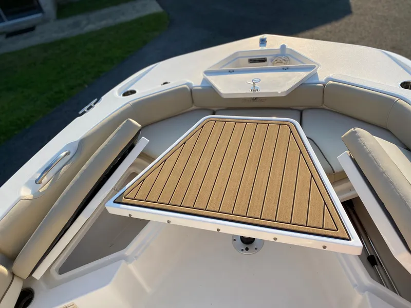 Slide: The Image of 2022 NauticStar 191 Hybrid boat bow with cushioned seating and wooden deck. - 16