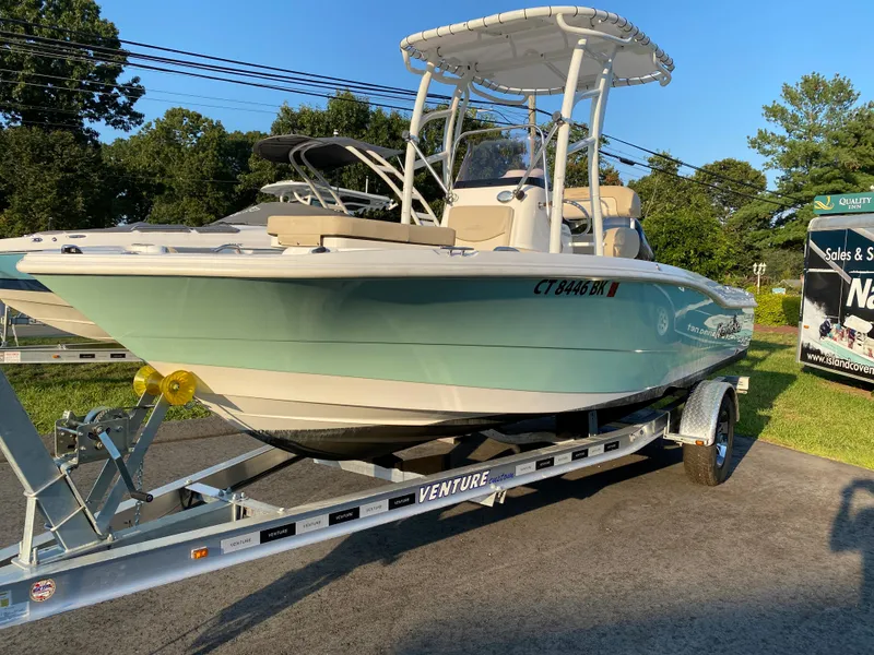 Slide: The Image of 2022 NauticStar 191 Hybrid boat on Venture trailer in outdoor setting. - 5