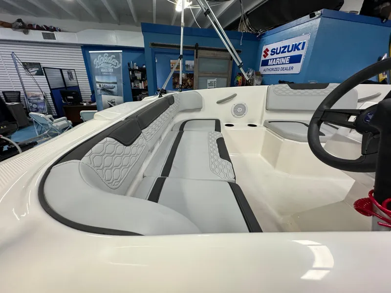 Slide: The Image of 2025 Bayliner Element M15 boat interior with seating and steering wheel in showroom. - 3