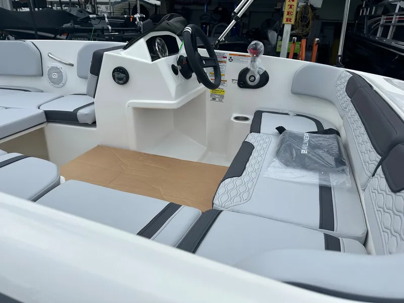 Slide: The Image of 2025 Bayliner Element M15 boat interior with modern seating and steering console. - 5
