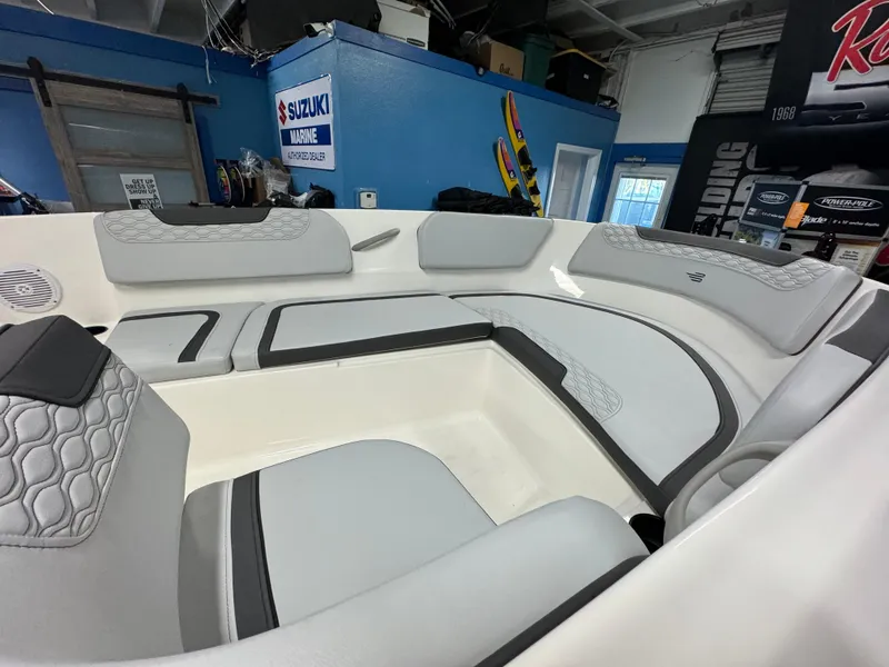 Slide: The Image of 2025 Bayliner Element M15 boat interior with gray seating in showroom. - 7