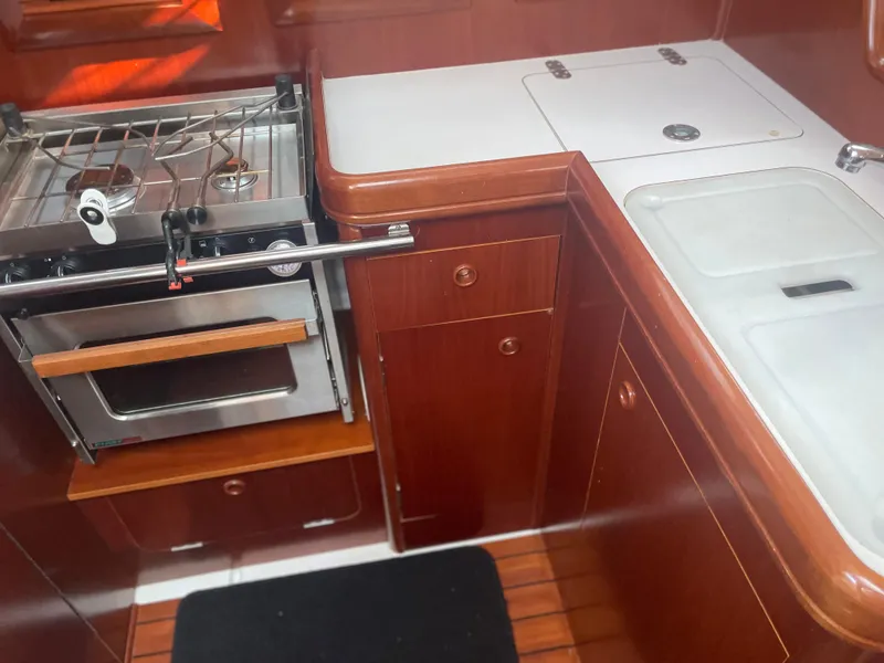 Slide: The Image of Galley kitchen in 2002 Beneteau 393 sailboat with stove, oven, and sink. - 10