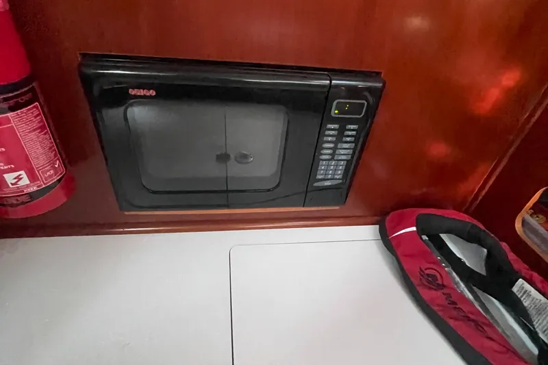 Slide: The Image of Microwave in the galley of a 2002 Beneteau 393 sailboat. - 12