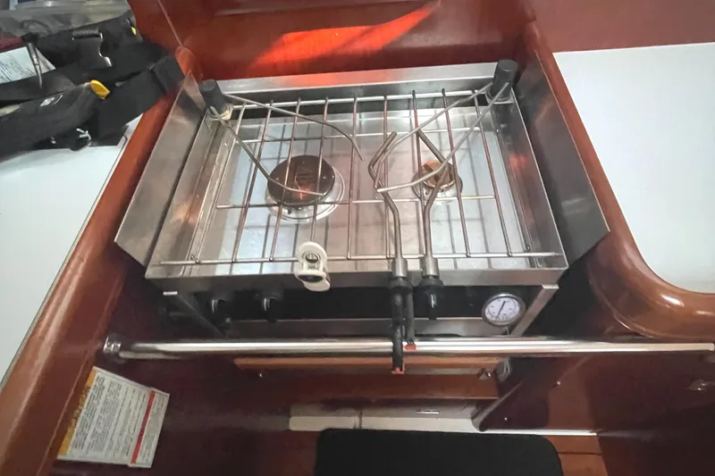 Slide: The Image of Beneteau 393 2002 model yacht kitchen stove with single burner and safety rail. - 19