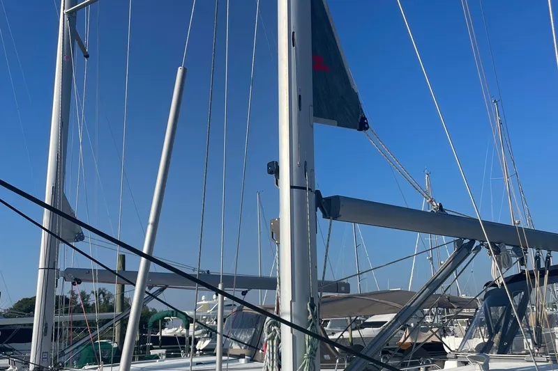 Slide: The Image of Beneteau 393 sailboat, 2002 model, docked at a marina with clear blue sky. - 3