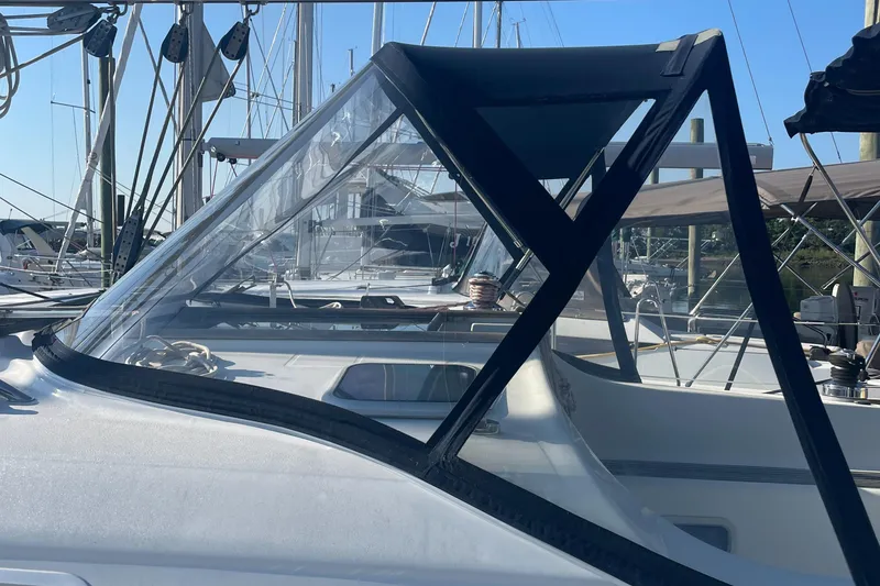Slide: The Image of Beneteau 393 sailboat, 2002 model, docked at marina with clear cockpit enclosure. - 4