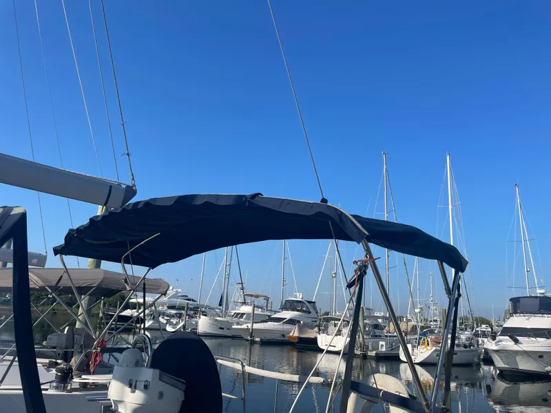 Slide: The Image of Beneteau 393 sailboat, 2002 model, docked in a marina with other boats. - 5