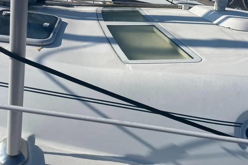 Slide: The Image of Deck of a 2002 Beneteau 393 sailboat with windows and rigging. - 6