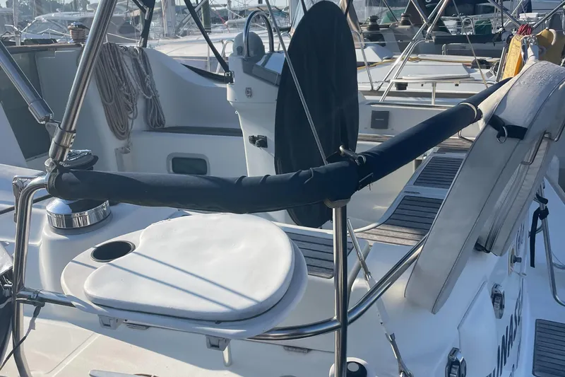 Slide: The Image of Cockpit view of a 2002 Beneteau 393 sailboat with steering wheel and seating. - 7