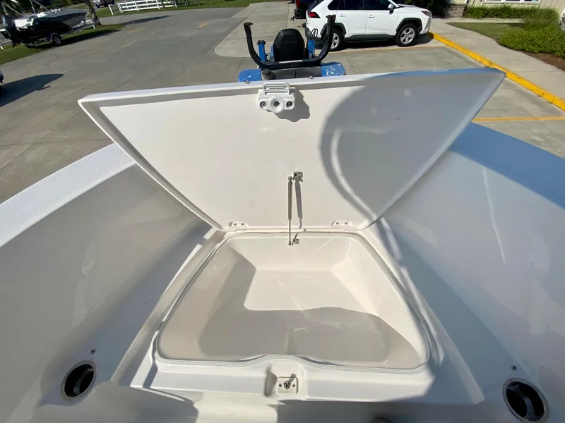 Slide: The Image of 2024 Robalo R180 Center Console boat storage compartment open. - 17