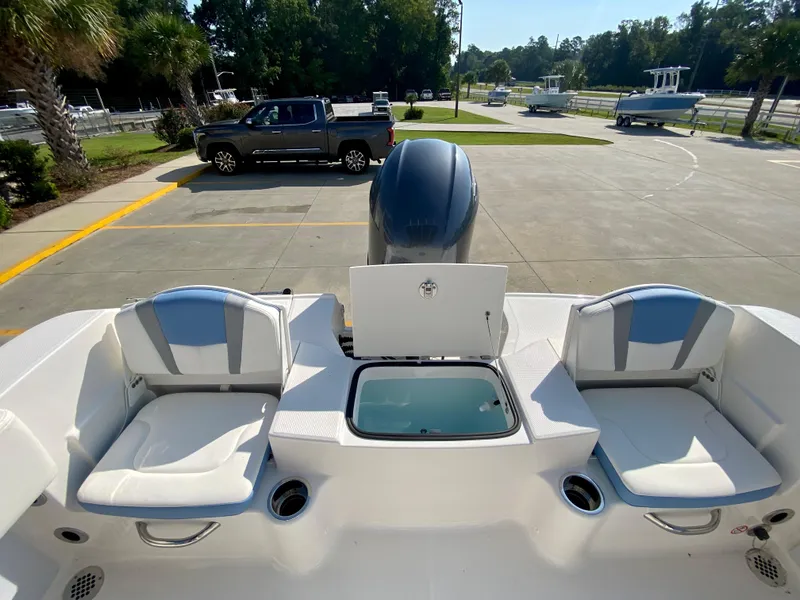 Slide: The Image of 2024 Robalo R180 Center Console boat with dual seating and storage compartment. - 8
