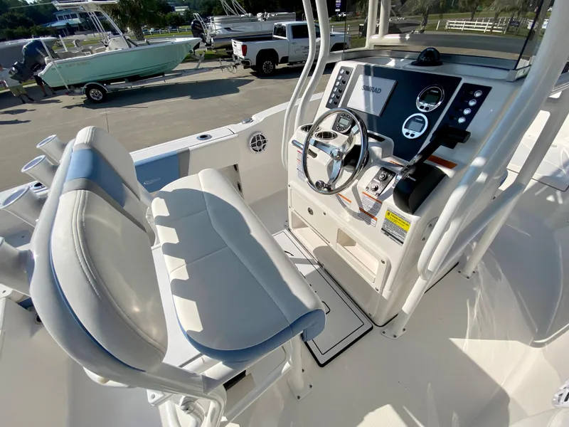 Slide: The Image of 2024 Robalo R180 Center Console boat interior with helm and seating. - 9