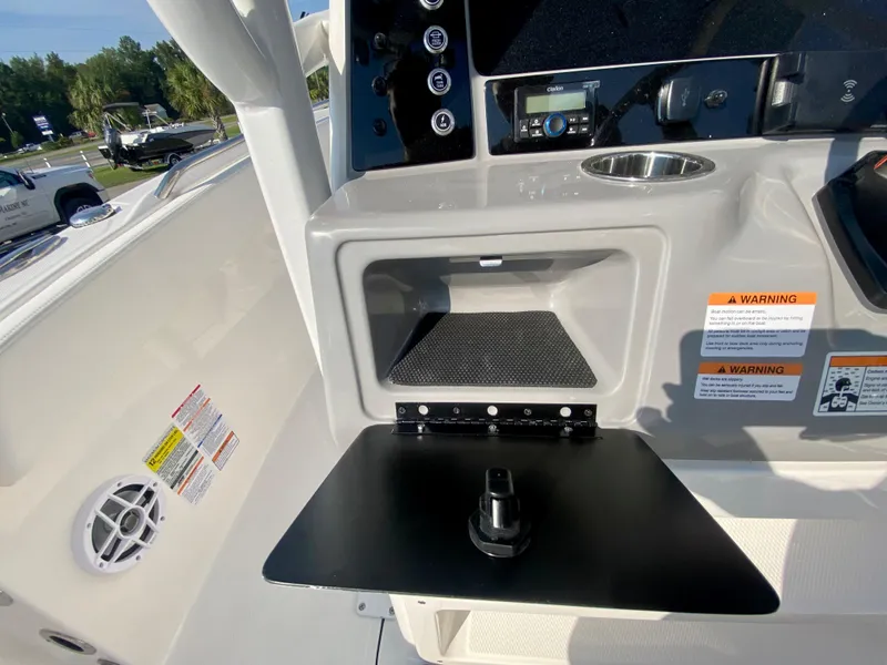 Slide: The Image of 2024 Robalo R232 Explorer boat console with storage compartment and control panel. - 15