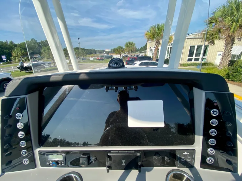Slide: The Image of 2024 Robalo R232 Explorer boat dashboard with navigation controls and display. - 16