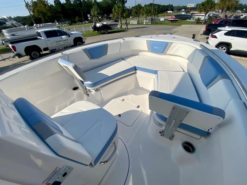 Slide: The Image of 2024 Robalo R232 Explorer boat interior with white and blue seating. - 19