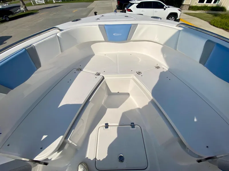 Slide: The Image of 2024 Robalo R232 Explorer boat interior with spacious seating and storage compartments. - 23
