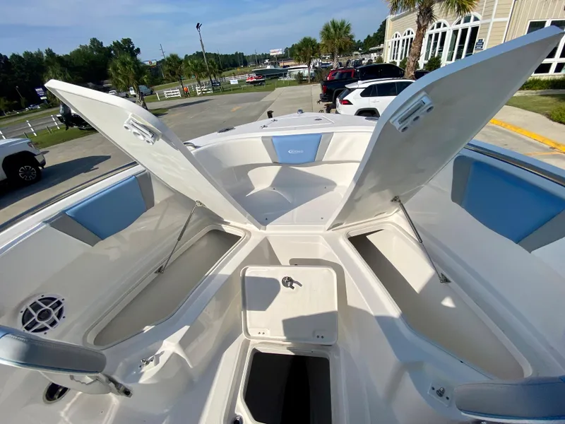 Slide: The Image of 2024 Robalo R232 Explorer boat interior with open storage compartments. - 24
