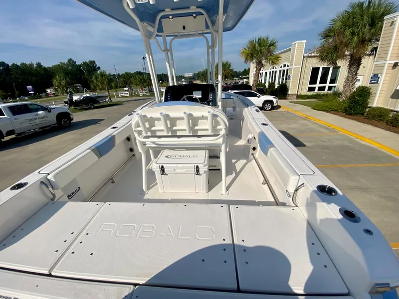 Slide: The Image of 2024 Robalo R232 Explorer boat interior with seating and storage. - 6