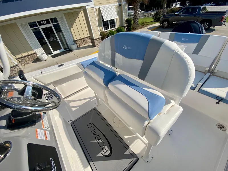 Slide: The Image of 2024 Robalo R232 Explorer boat interior with dual seating and steering wheel. - 10