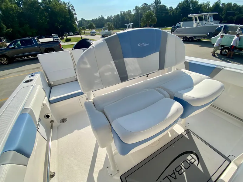 Slide: The Image of 2024 Robalo R232 Explorer boat interior with cushioned seating. - 11