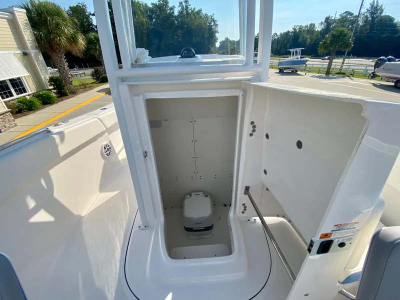 Slide: The Image of 2024 Robalo R232 Explorer boat interior with open storage compartment. - 21