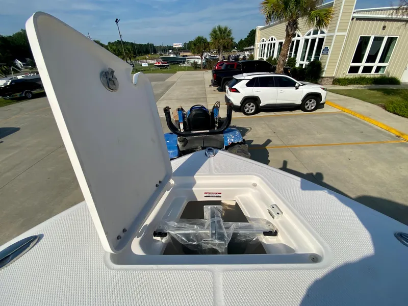 Slide: The Image of 2024 Robalo R232 Explorer boat with open storage compartment in parking lot. - 26