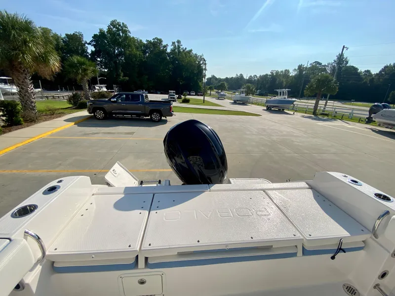 Slide: The Image of 2024 Robalo R232 Explorer boat rear view with outboard motor in parking lot. - 7