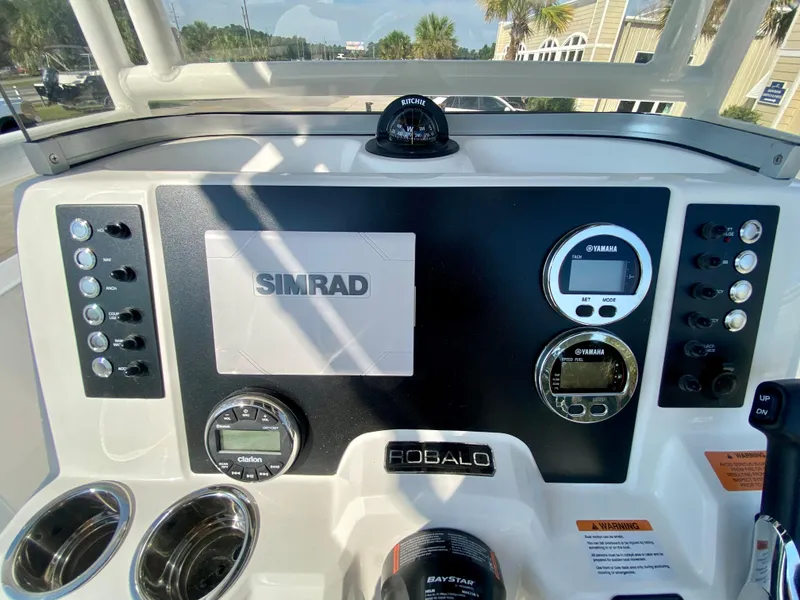 Slide: The Image of 2024 Robalo R180 Center Console dashboard with Simrad electronics and control panel. - 11