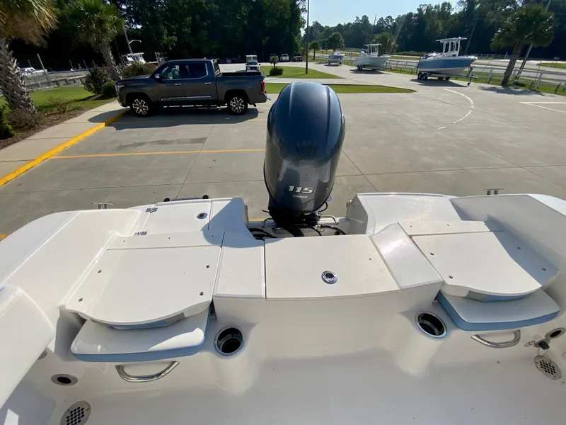 Slide: The Image of 2024 Robalo R180 Center Console boat with 115 HP outboard motor, rear view. - 6