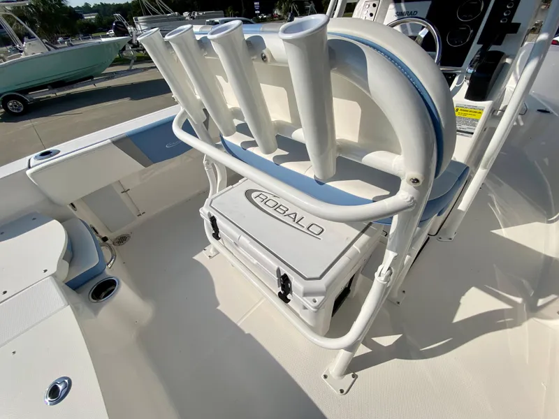 Slide: The Image of 2024 Robalo R180 Center Console boat interior with rod holders and cooler. - 7