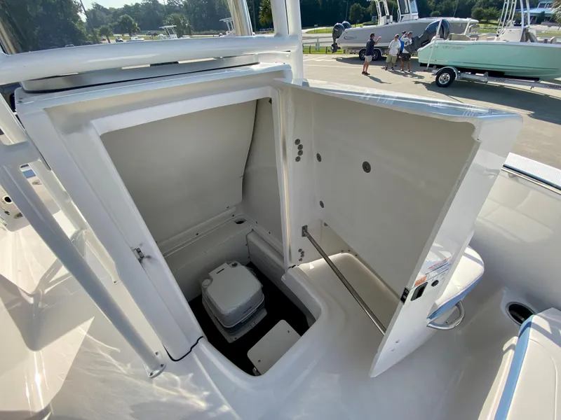 Slide: The Image of 2024 Robalo R180 Center Console boat with open storage compartment. - 14