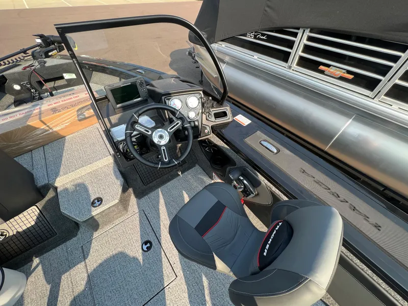 Slide: The Image of 2024 Tracker Targa V19 boat cockpit with steering wheel and seating. - 11