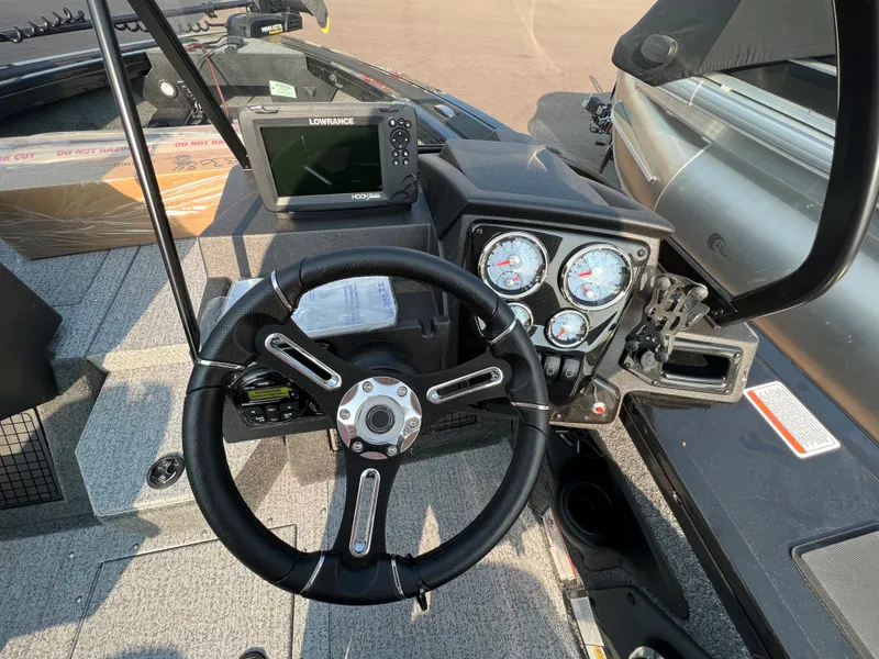 Slide: The Image of 2024 Tracker Targa V19 boat dashboard with steering wheel and navigation system. - 12