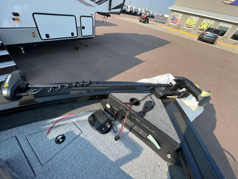 Slide: The Image of 2024 Tracker Targa V19 boat with trolling motor in dealership lot. - 14