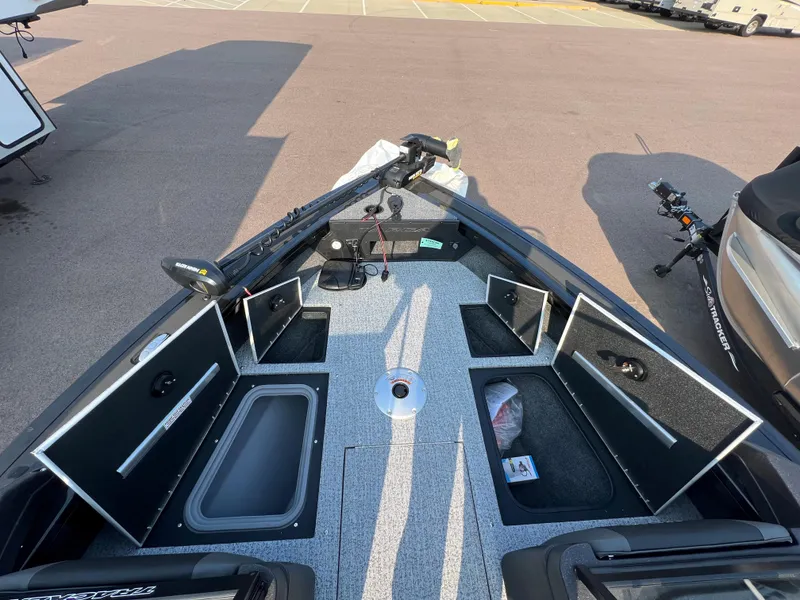 Slide: The Image of 2024 Tracker Targa V19 boat with open storage compartments and fishing gear. - 7