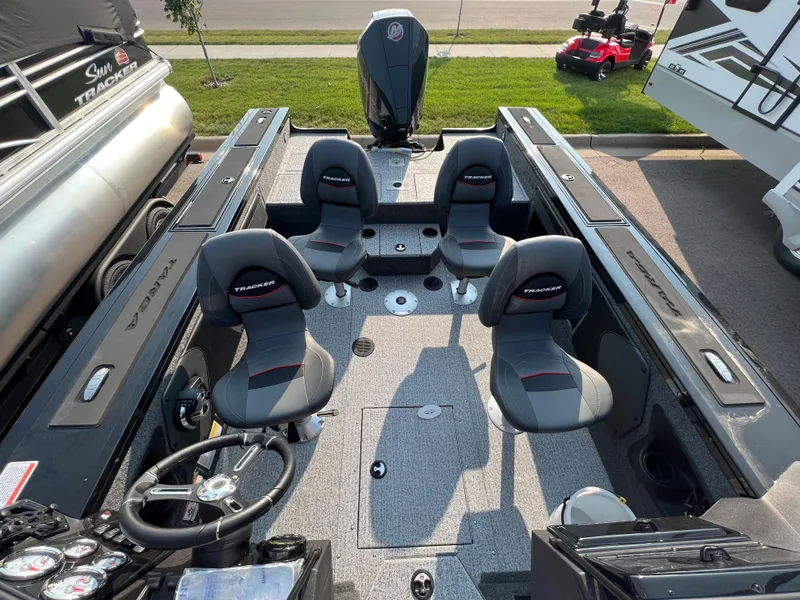 Slide: The Image of 2024 Tracker Targa V19 boat interior with four seats and steering console. - 8