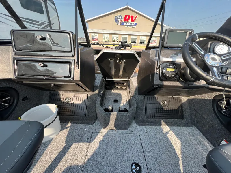 Slide: The Image of 2024 Tracker Targa V19 boat interior with steering wheel and storage compartments. - 9