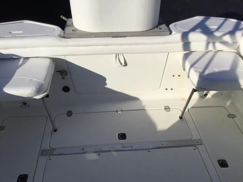Slide: The Image of Interior of a 2000 Doral Thunder Pro 240 boat with white seating. - 4