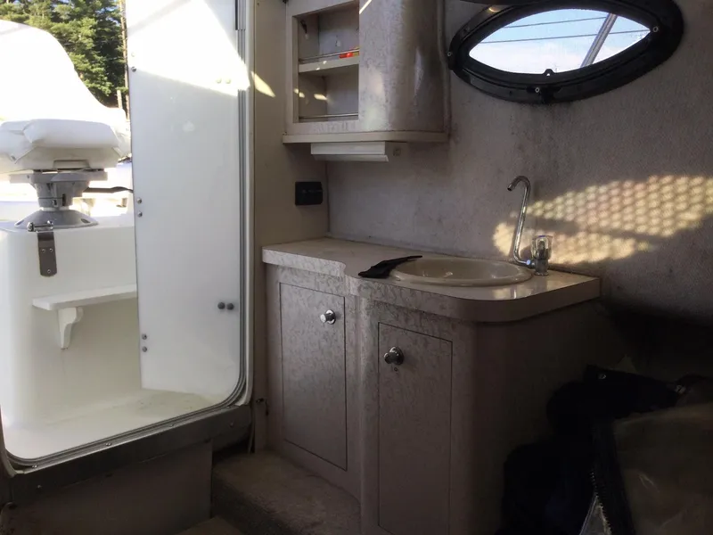 Slide: The Image of Interior of 2000 Doral Thunder Pro 240 boat with sink and storage cabinets. - 6