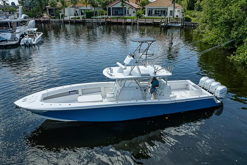 The Image of 2018 Invincible 42 boat on calm water, featuring sleek design and powerful engines. - 0