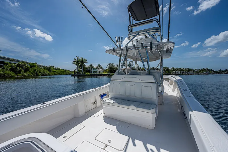 Slide: The Image of Invincible 42 boat, 2018 model, on calm water under a clear blue sky. - 21