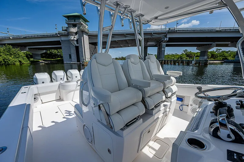 Slide: The Image of Luxury seating on 2018 Invincible 42 boat, under a bridge, with scenic water view. - 26