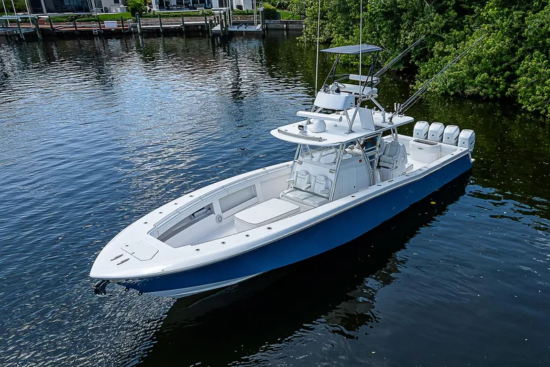 Slide: The Image of 2018 Invincible 42 boat on calm water, featuring sleek design and multiple outboard engines. - 8