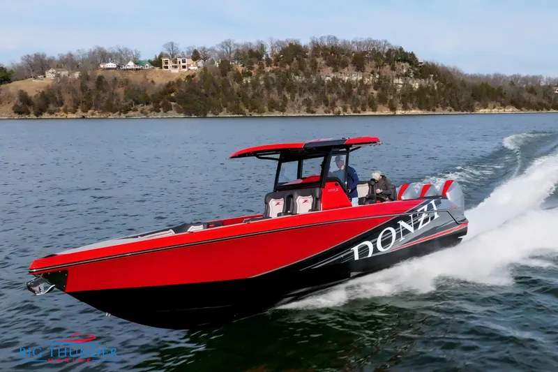 Slide: The Image of 2024 Donzi 39 VRZ speedboat cruising on a lake with scenic background. - 11