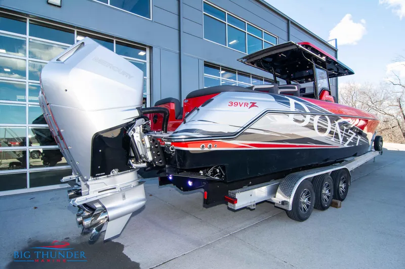 Slide: The Image of 2024 Donzi 39 VRZ powerboat on a trailer outside a modern building. - 21