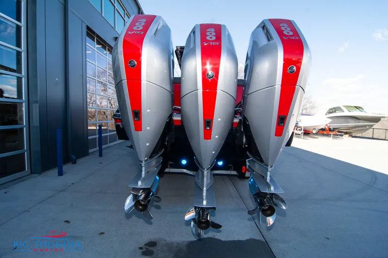 Slide: The Image of 2024 Donzi 39 VRZ with triple outboard engines at a marina. - 24